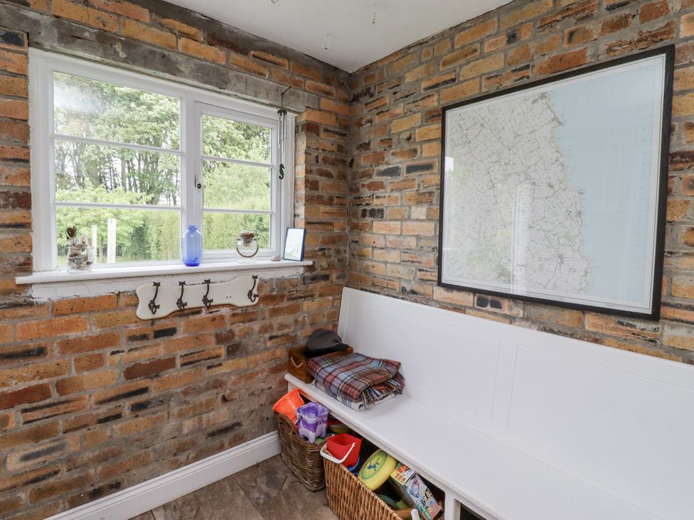 A utility room with a bench and map on the wall at Driftwood