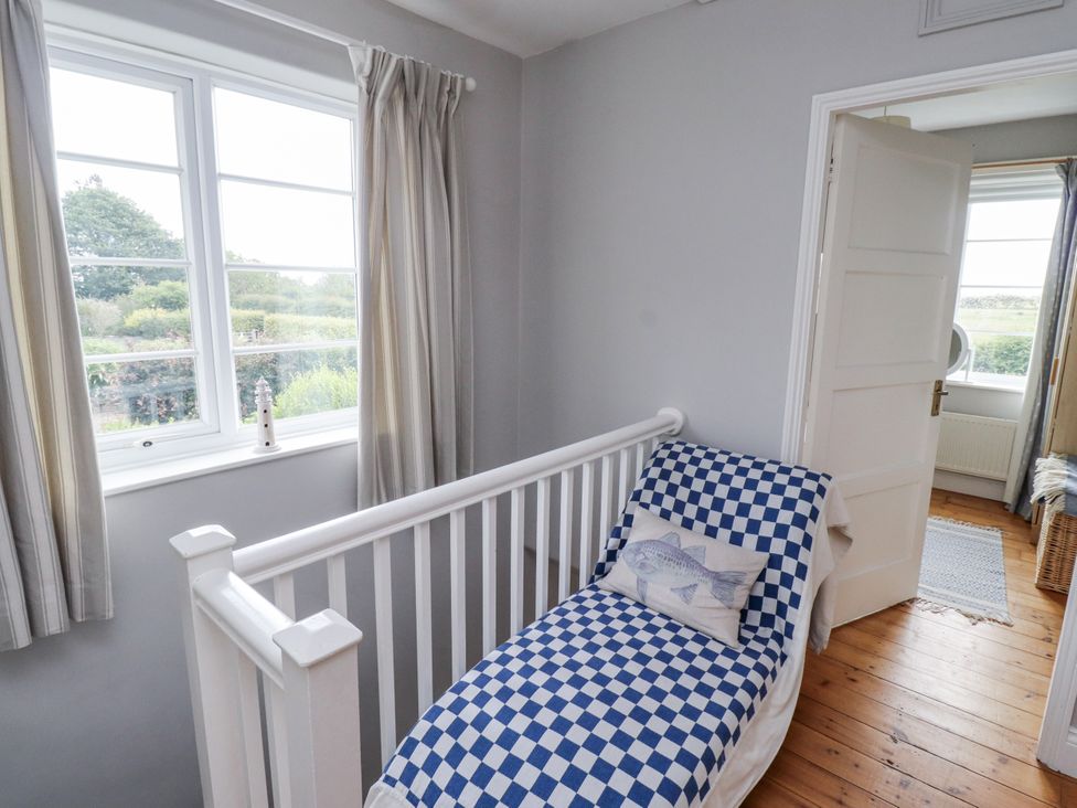 A bedroom with a bed and window at Driftwood