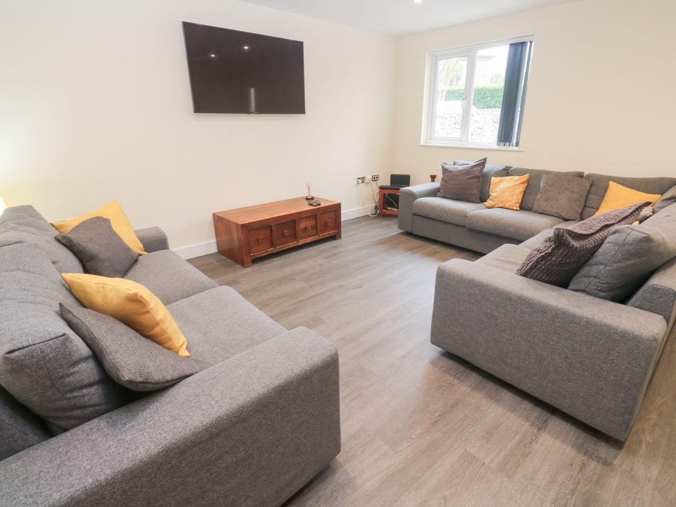 A living room with a sofa and television at Boslowen in Portreath