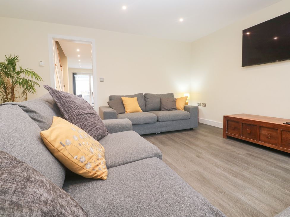 A living room with sofas and a coffee table at Boslowen in Portreath