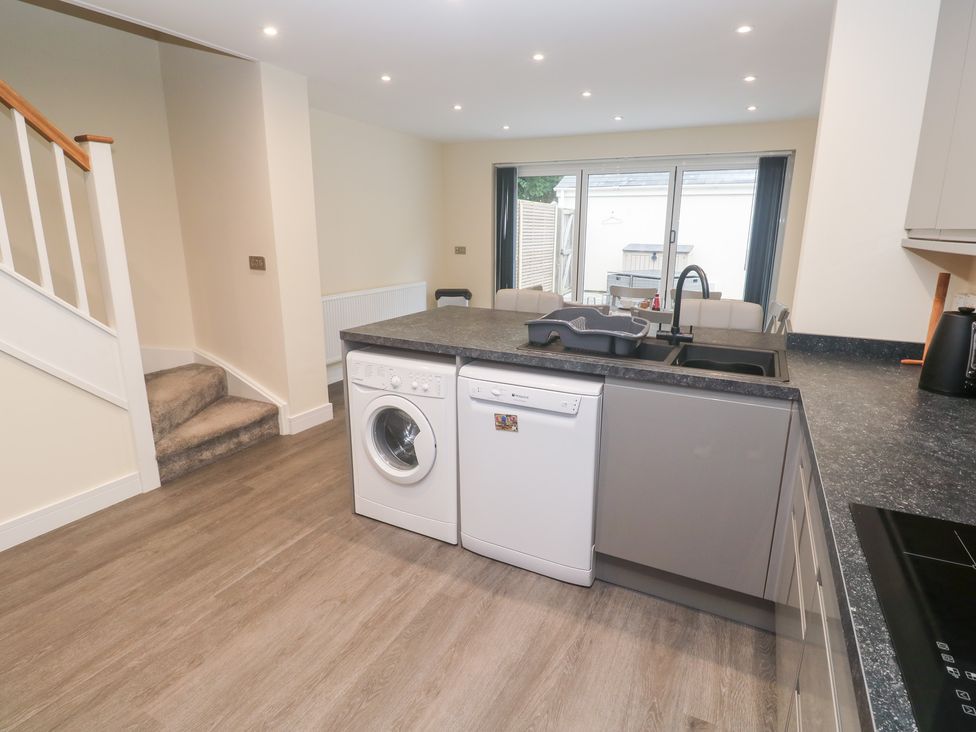 A kitchen with appliances including a washing machine and dishwasher at Boslowen Portreath
