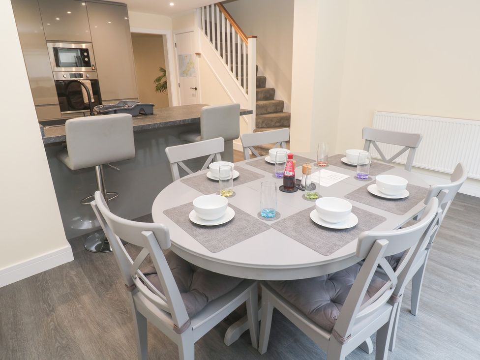 A dining room with a table and chairs at Boslowen in Portreath