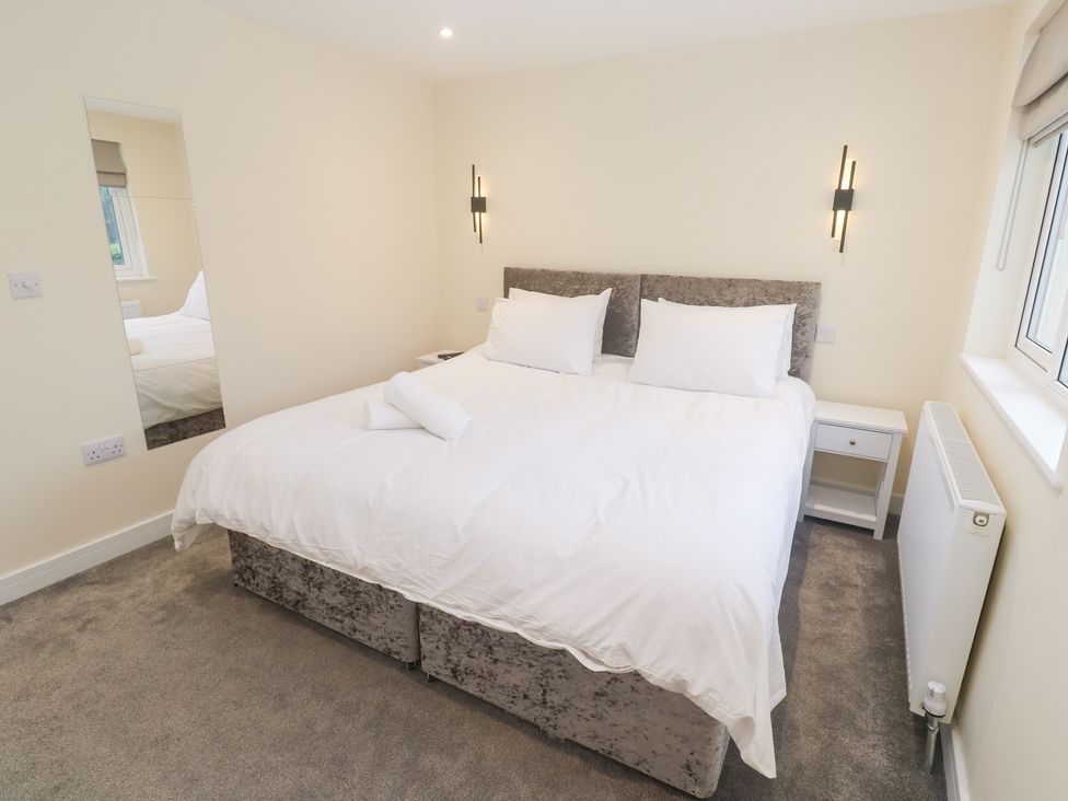 A bedroom with a bed and bedside table at Boslowen in Portreath