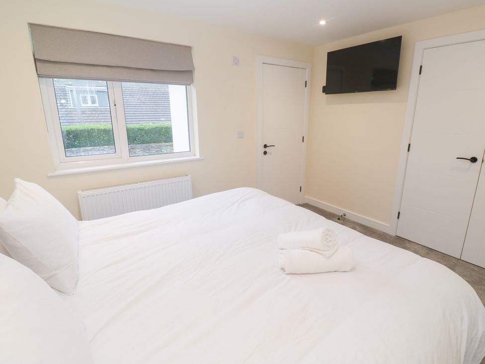 A bedroom with a bed and television at Boslowen in Portreath