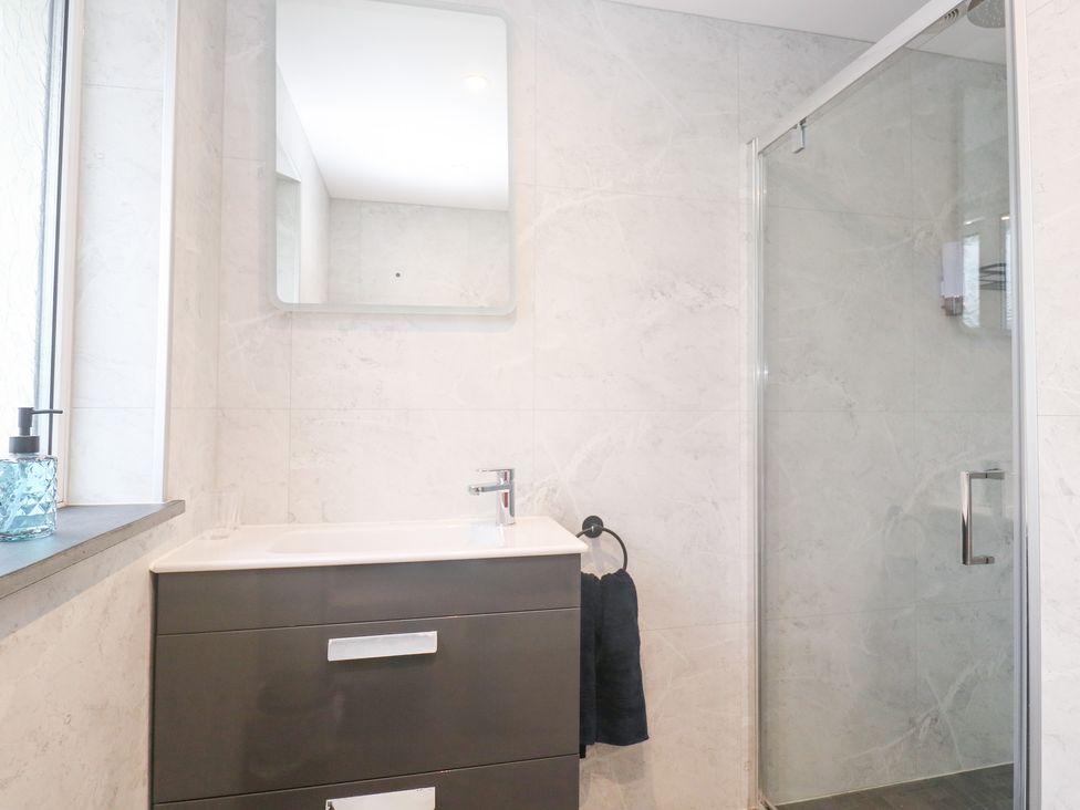 A bathroom with a sink and shower at Boslowen in Portreath
