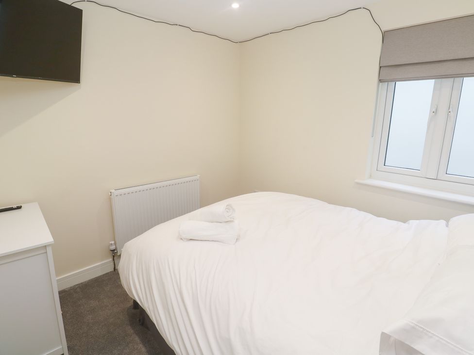 A bedroom with a bed and television at Boslowen in Portreath