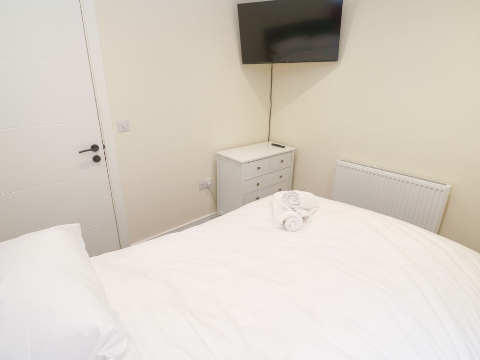 A bedroom with a bed and television at Boslowen in Portreath