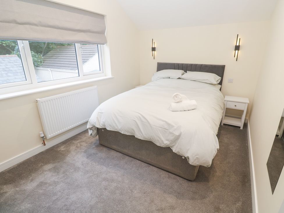 A bedroom with a bed and bedside table at Boslowen in Portreath