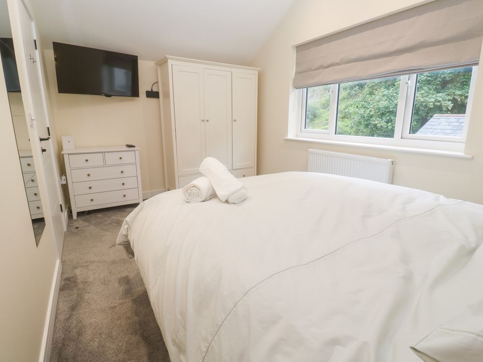 A bedroom with a bed and television at Boslowen in Portreath