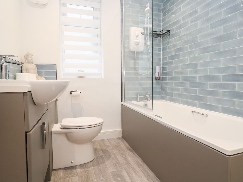 A bathroom with a bathtub sink and shower at Boslowen in Portreath