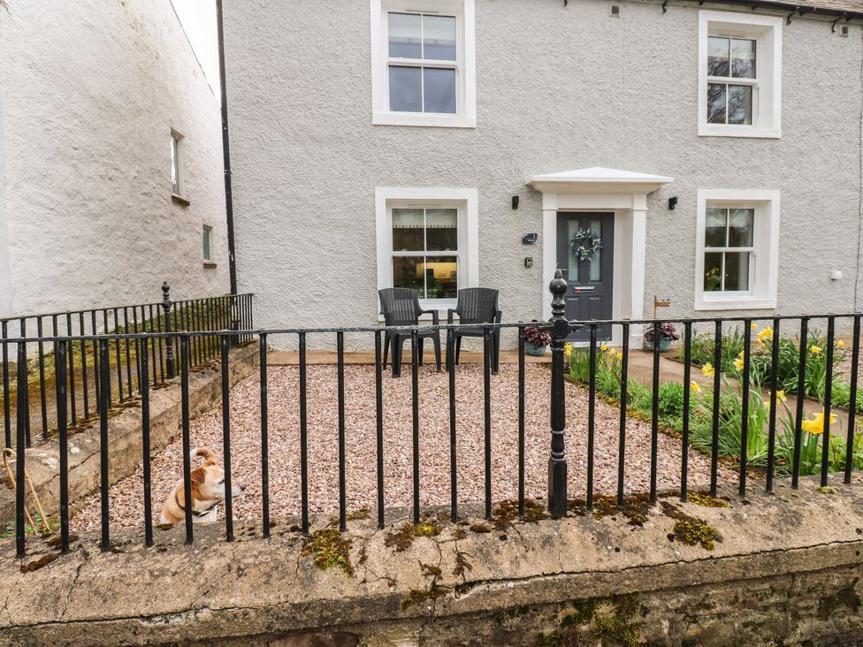 A house with a fence and chairs in front at 1 Brookside in Warcop