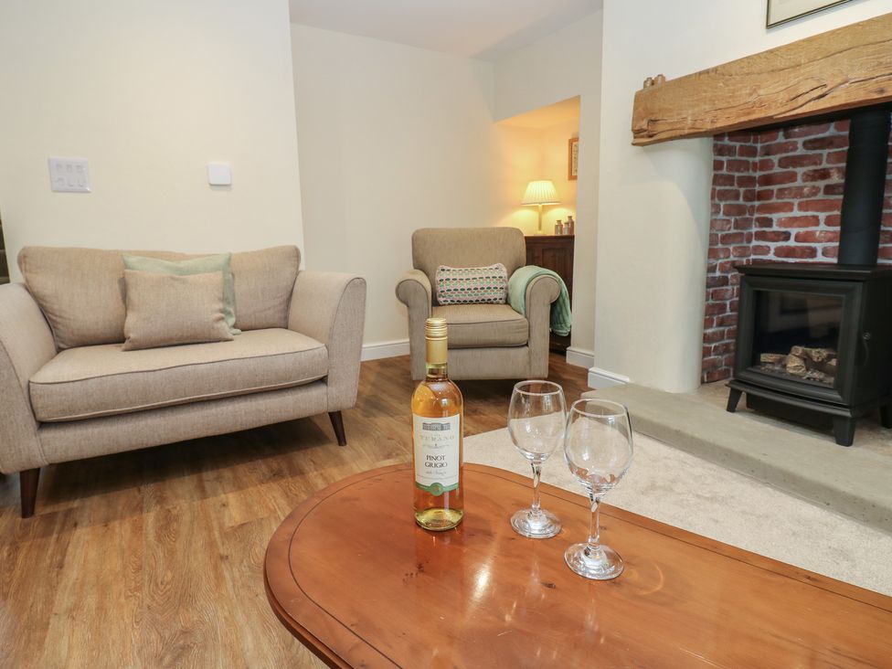A living room with a sofa and coffee table at 1 Brookside in Warcop