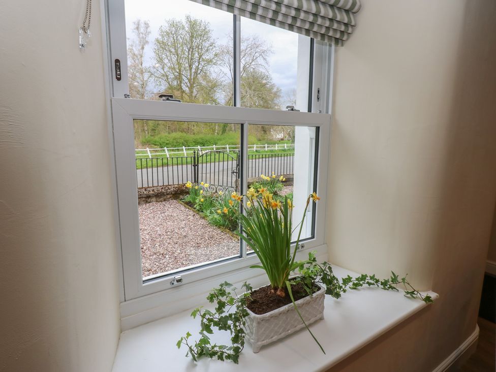 A window with a flower pot on the sill at 1 Brookside in Warcop