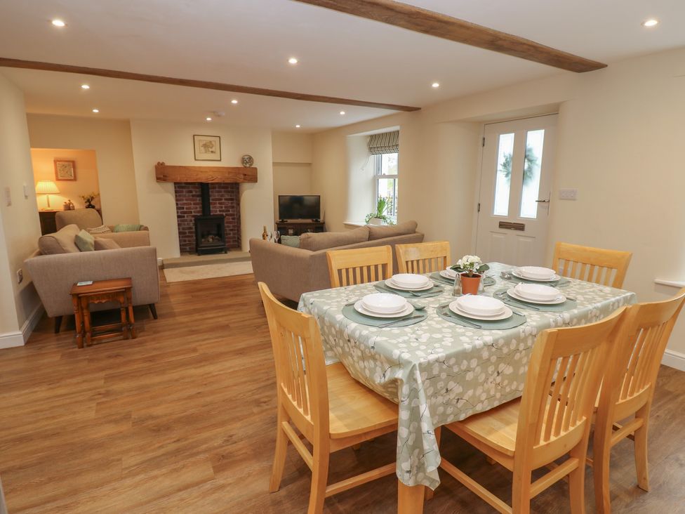 A dining room with a table and chairs at 1 Brookside in Warcop
