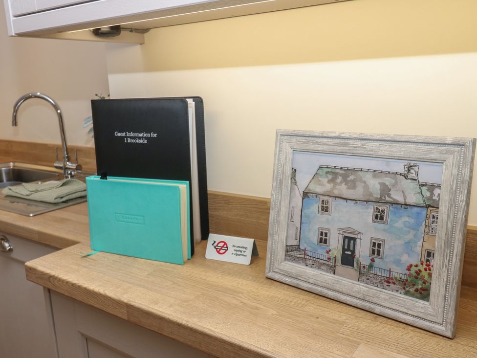 A kitchen countertop with a sink and various items at 1 Brookside in Warcop