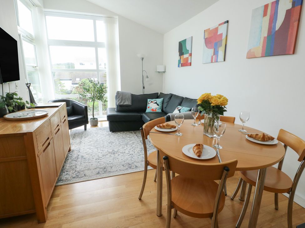 A dining room with a table set for breakfast at Seaview in Benllech near Red Wharf Bay