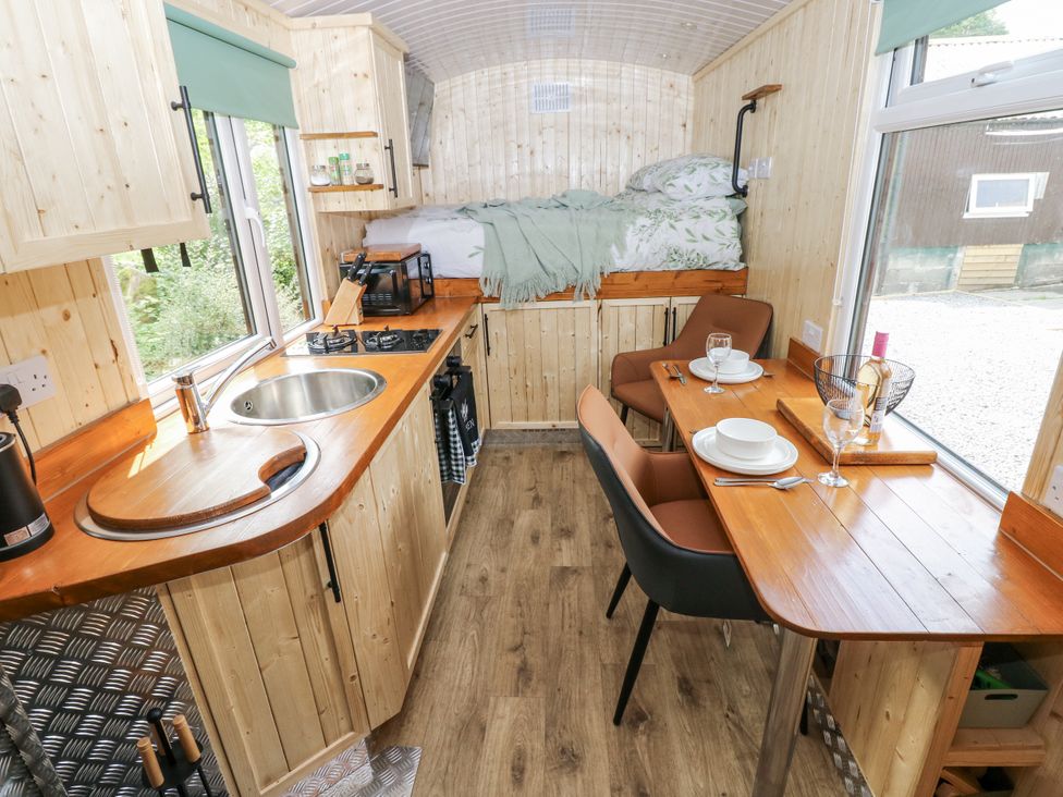 A kitchen with a sink and stove at The Hamper in Felingwm near Carmarthen