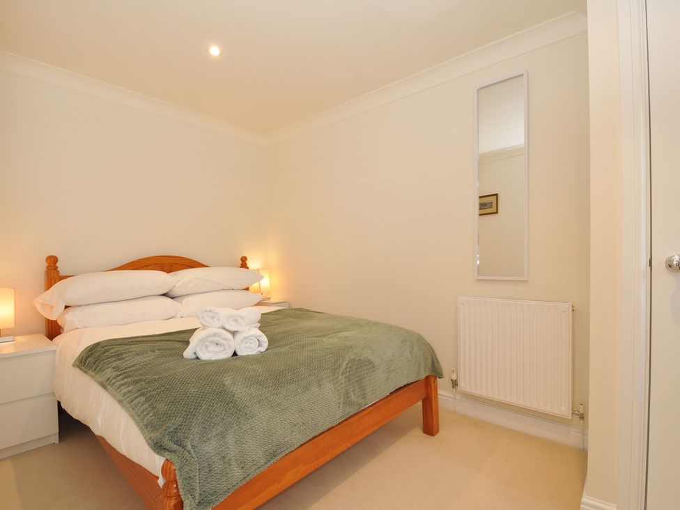 A bedroom with a bed and nightstands at Bodare 8 in Daymer Bay