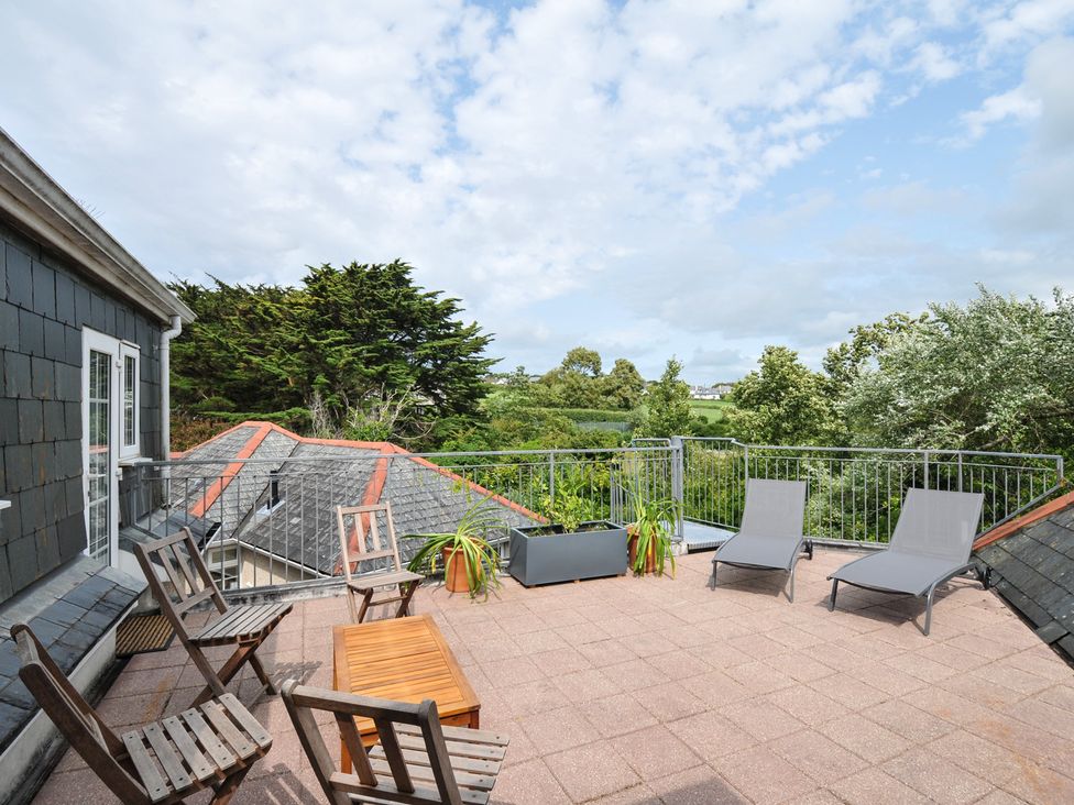 An outdoor terrace with seating and plants at Bodare 8 in Daymer Bay