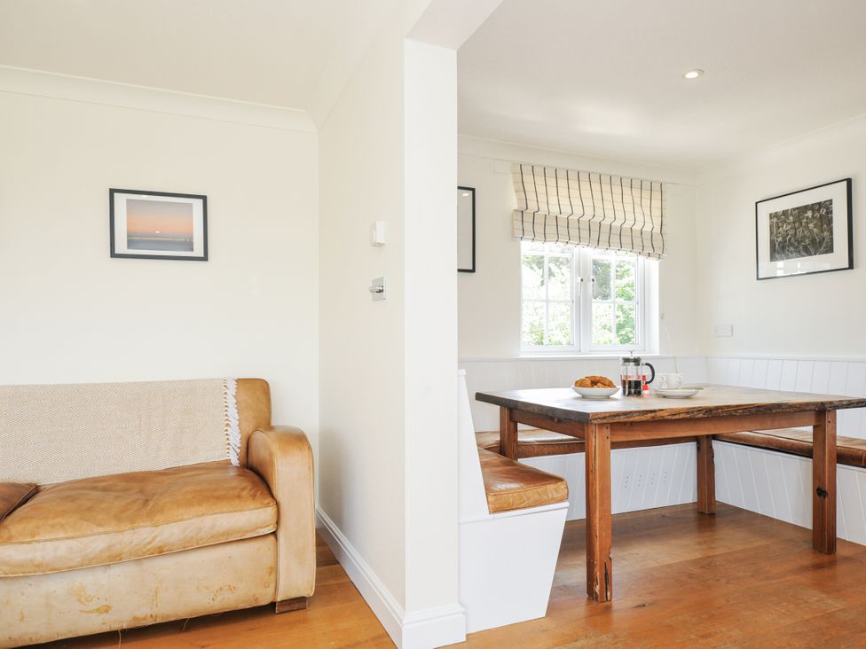 A dining room with a table and chairs at Bodare 8 Daymer Bay