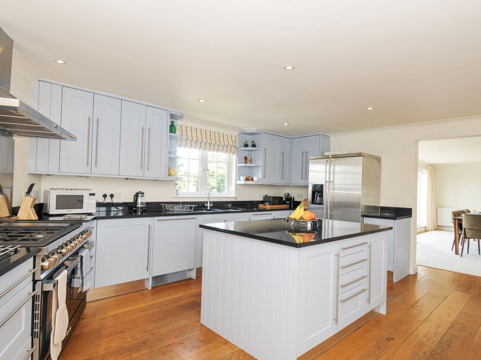 A kitchen with an island and appliances at Bodare 8 in Daymer Bay