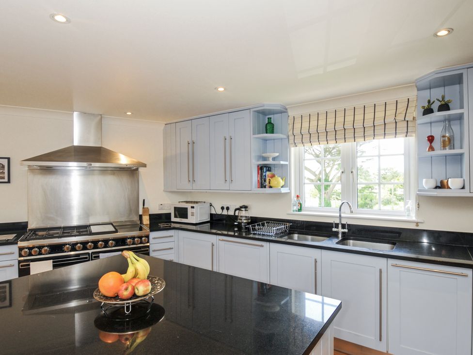 A kitchen with cabinets and appliances at Bodare 8 in Daymer Bay