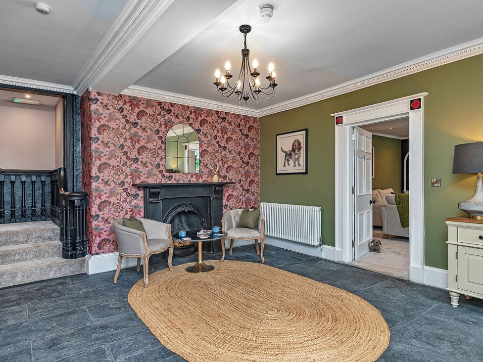 A living room with a fireplace and armchairs at Snowdonia Manor in Dolgellau