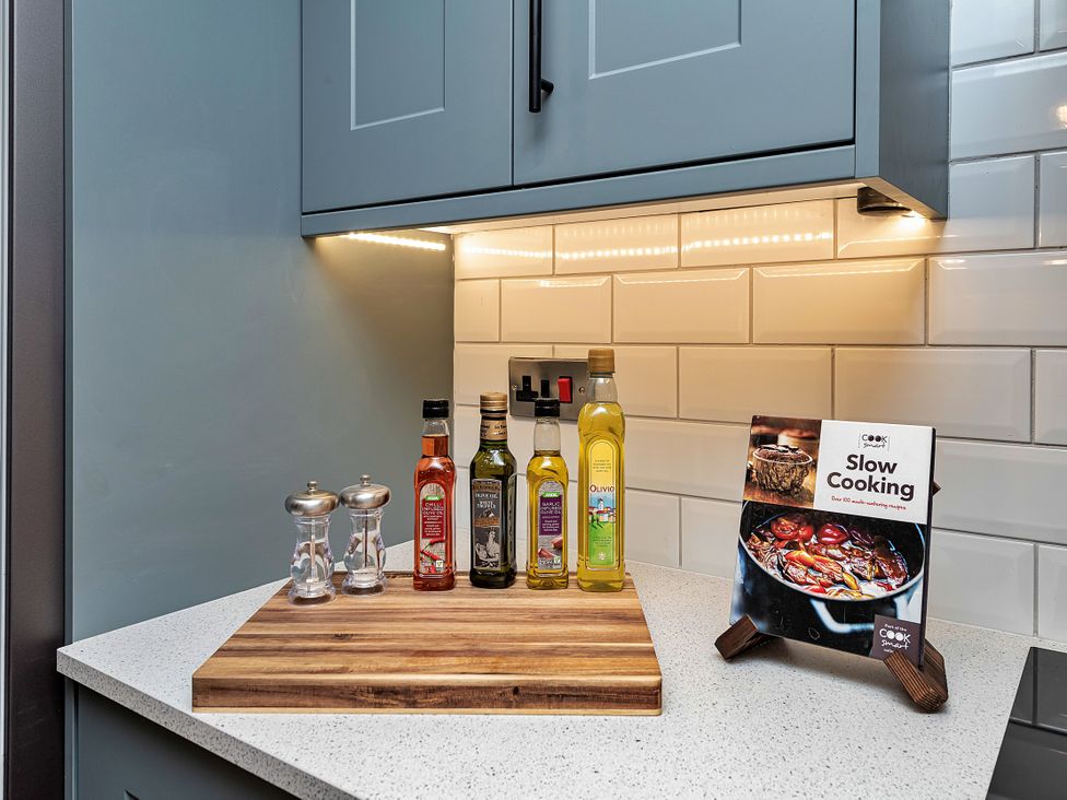 A kitchen with condiments and a cookbook at Snowdonia Manor in Dolgellau