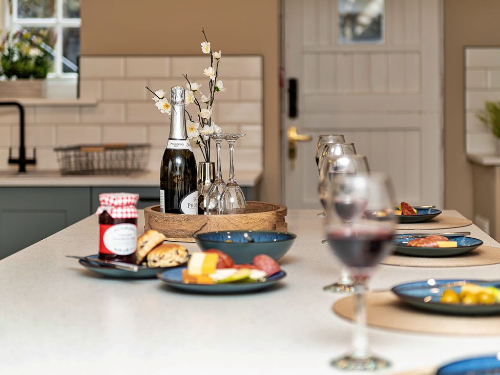 A kitchen with food and drinks arranged on a countertop at Snowdonia Manor in Dolgellau