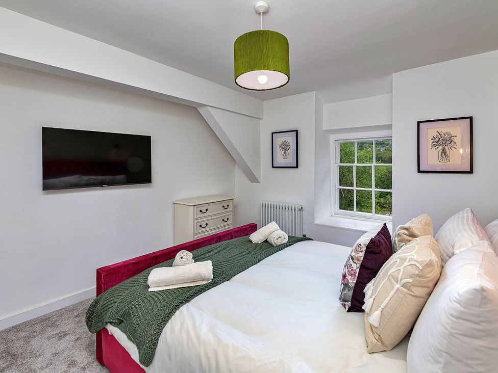 A bedroom with a bed and television at Snowdonia Manor in Dolgellau