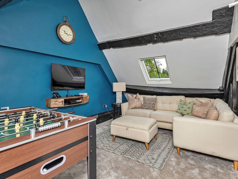 A snug with a foosball table and a television at Snowdonia Manor in Dolgellau