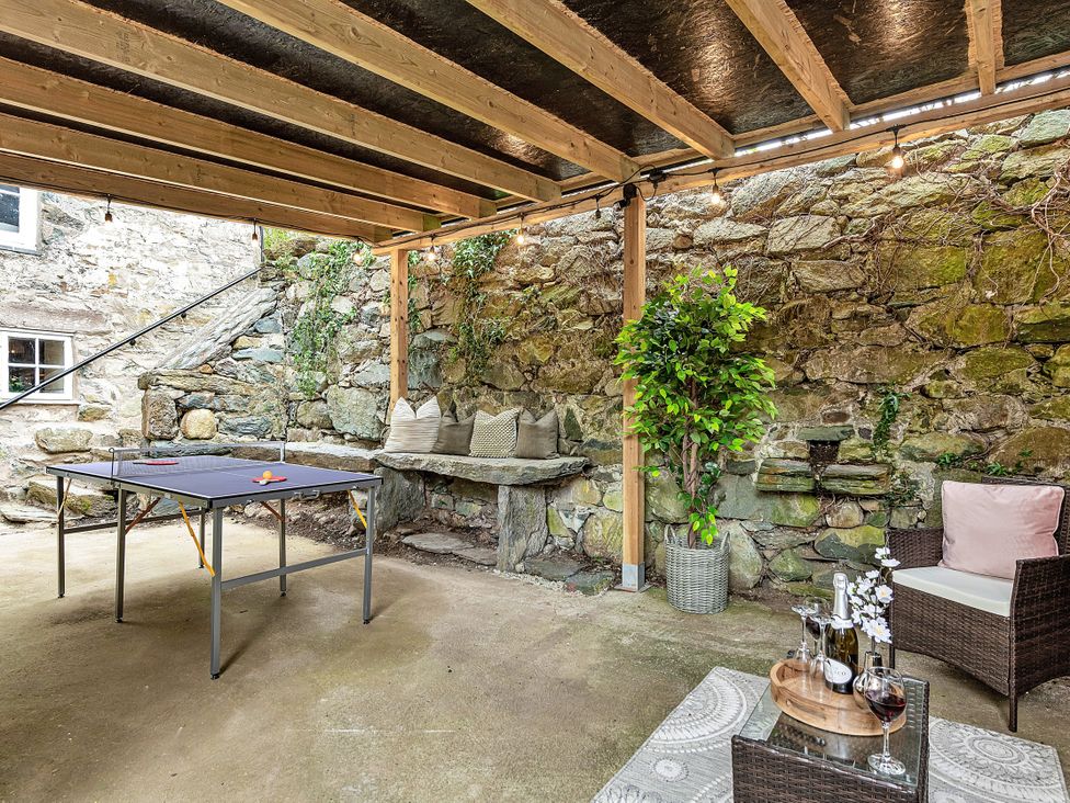 An outdoor patio with a table and chairs at Snowdonia Manor in Dolgellau