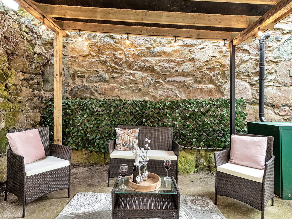 An outdoor seating area with chairs and a table at Snowdonia Manor in Dolgellau