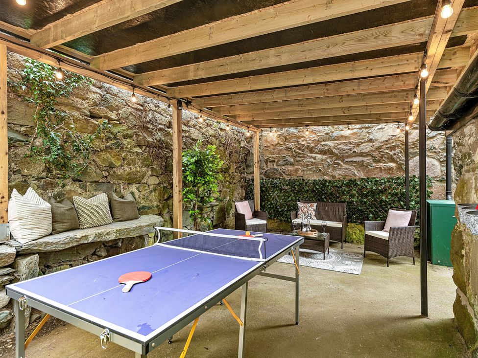 An outdoor sitting area with a ping pong table at Snowdonia Manor in Dolgellau