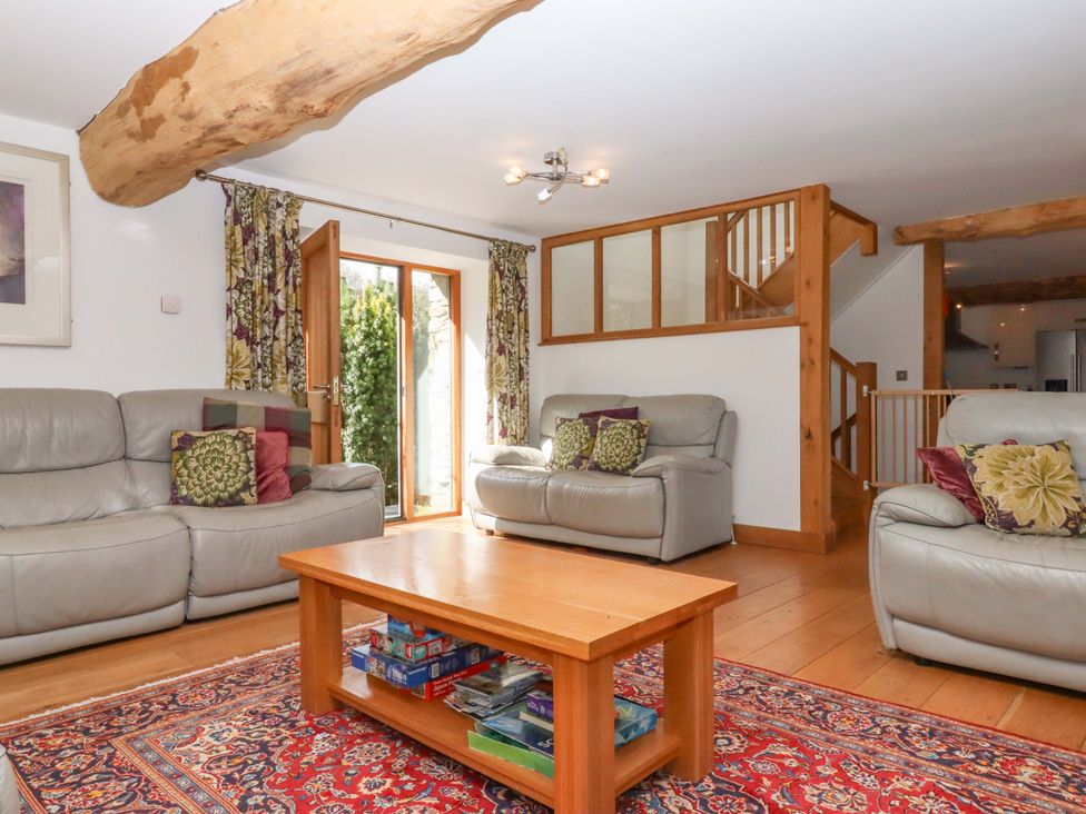 A living room with sofas and a coffee table at Swallows Reach Halwell