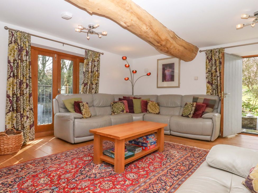 A living room with a sofa and coffee table at Swallows Reach Halwell