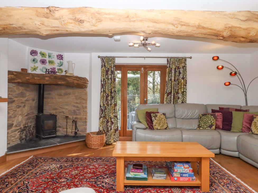 A living room with a sofa and coffee table at Swallows Reach in Halwell