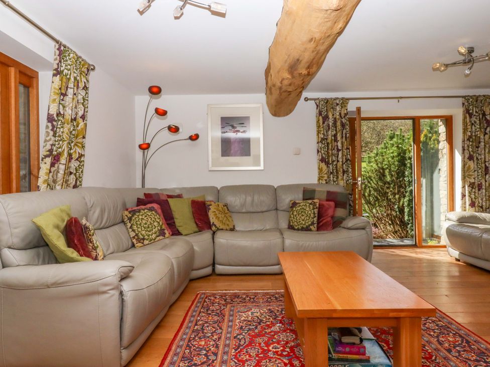 A living room with a sofa and coffee table at Swallows Reach Halwell