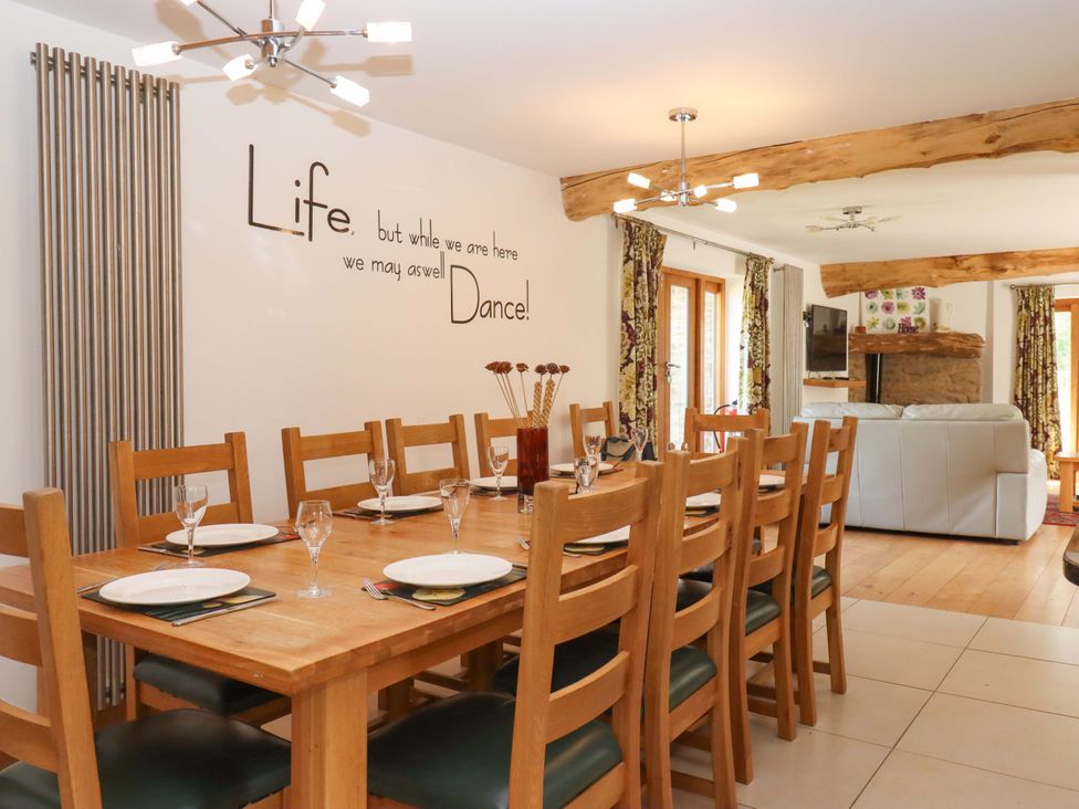 A dining room with a table set for dinner at Swallows Reach Halwell
