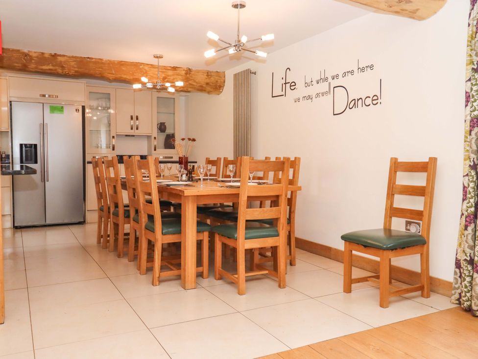 A dining room with a large table and chairs at Swallows Reach Halwell