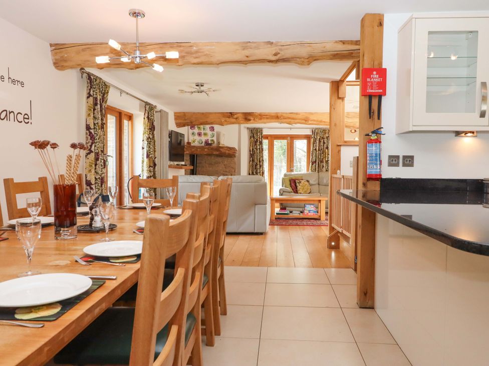 A dining room with a large table and chairs at Swallows Reach in Halwell