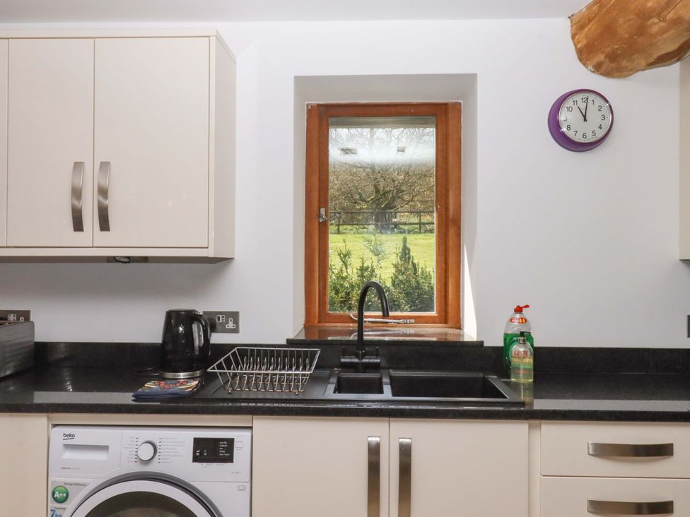 A kitchen with a sink and window at Swallows Reach Halwell