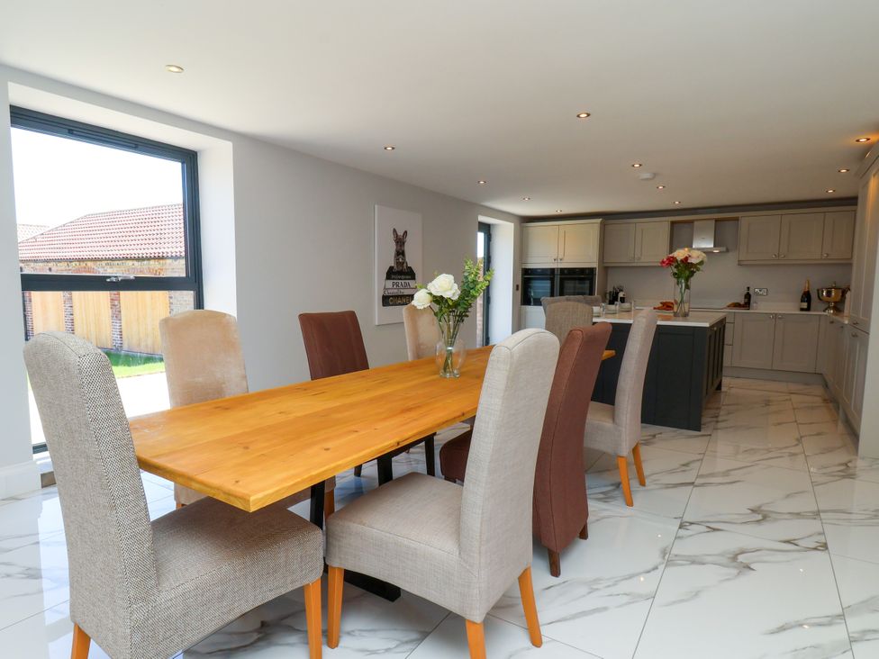 A dining room with a table and chairs in Plot Four - Italian Terraced Garden Harpham near Nafferton