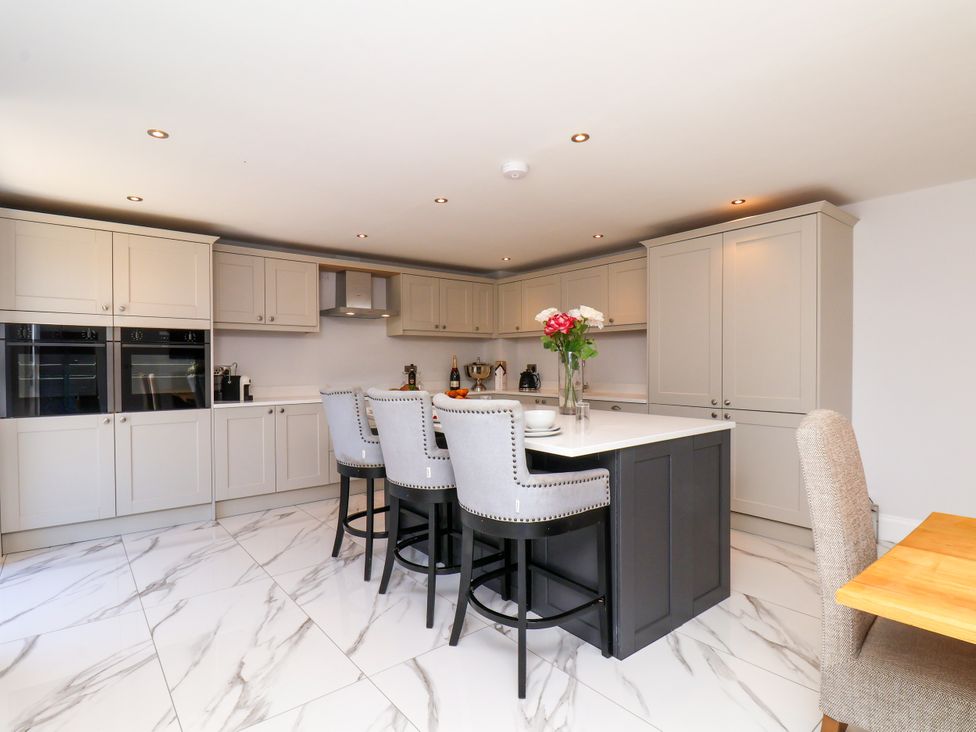 A kitchen with bar stools and a counter at Plot Four - Italian Terraced Garden Harpham near Nafferton