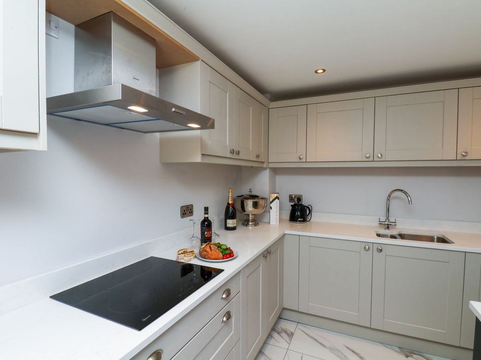 A kitchen with a cooker and sink at Plot Four - Italian Terraced Garden Harpham near Nafferton