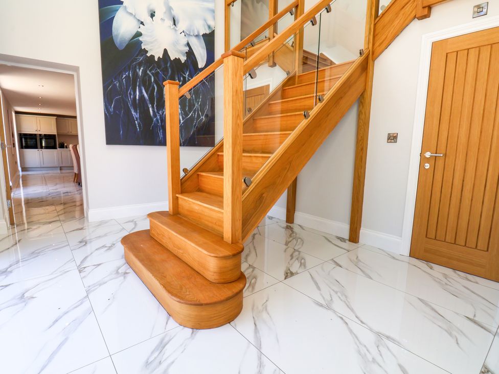 An entrance hall with a staircase and a door at Plot Four - Italian Terraced Garden, Harpham near Nafferton