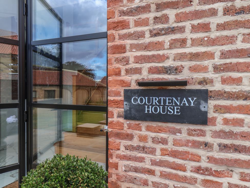 An entrance with a nameplate at Courtenay House in Harpham near Nafferton