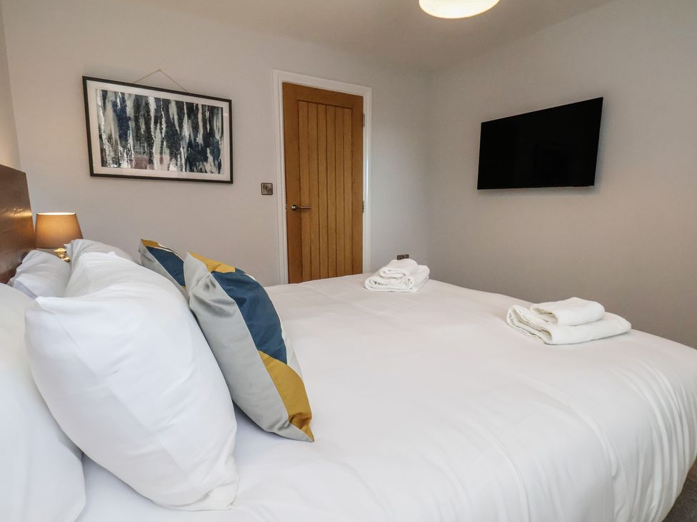 A bedroom with a bed and wall art at Courtenay House Harpham near Nafferton