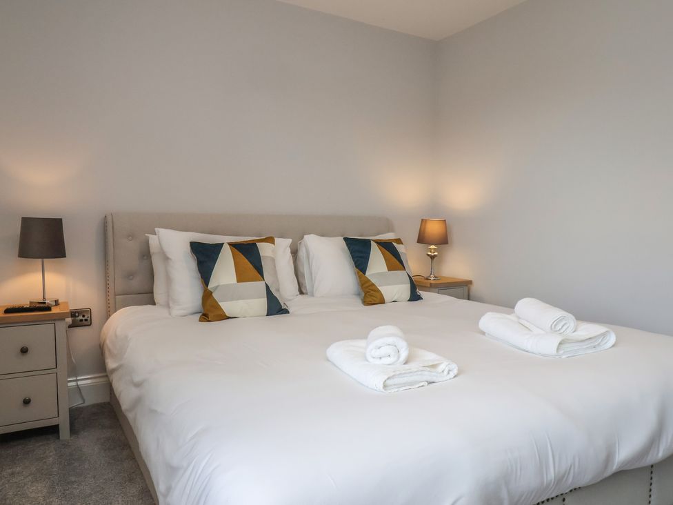 A bedroom with a double bed and linens at Courtenay House Harpham near Nafferton