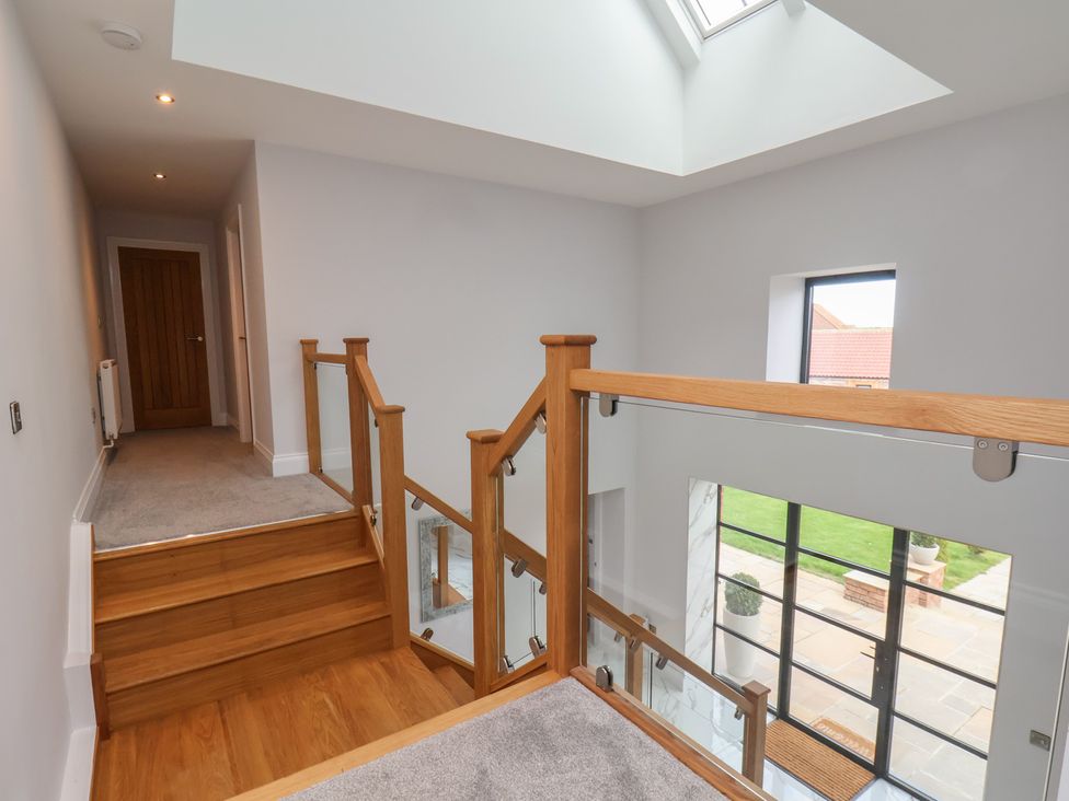 A hallway with stairs and a skylight at Courtenay House Harpham near Nafferton